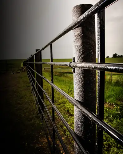 A ZahnTech composite post holding a steel rail fence